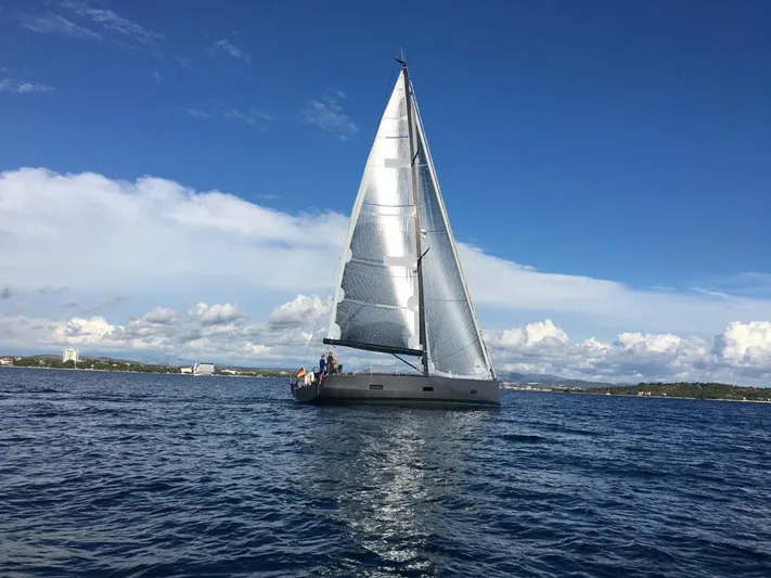Sultans Of Swing Yacht Photos Pics Sailing yacht Solaris 50 with carbon mast on open sea under clear blue sky.