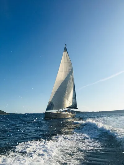 Sultans Of Swing Yacht Photos Pics Sailing yacht Solaris 50 with carbon mast gliding on open sea under clear blue sky.
