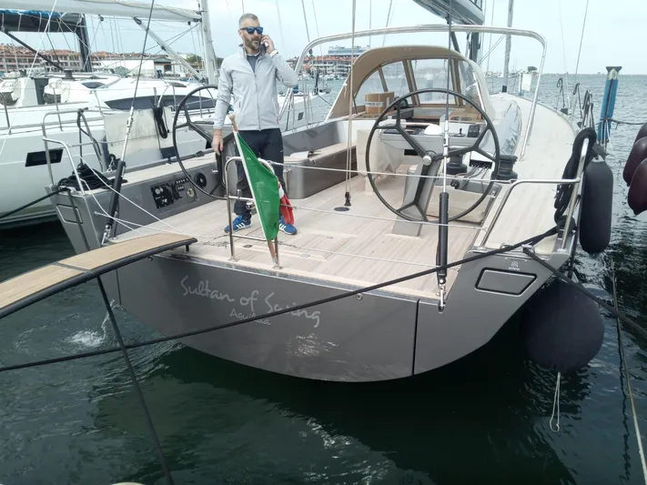 Sultans Of Swing Yacht Photos Pics Sleek Solaris 50 yacht with carbon mast, docked, featuring dual steering wheels and a person on deck.