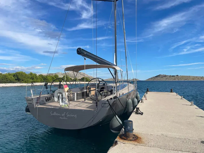 Sultans Of Swing Yacht Photos Pics Sleek 2020 Solaris 50 yacht with carbon mast docked by a scenic pier.