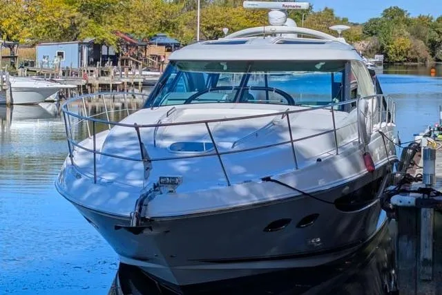 Nautalia Yacht Photos Pics 2013 Sea Ray 470 Sundancer yacht docked in a serene marina setting.