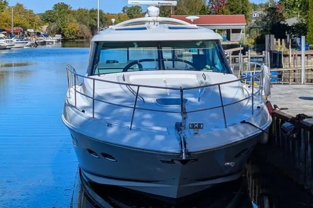 Nautalia Yacht Photos Pics 2013 Sea Ray 470 Sundancer yacht docked in a serene marina setting.