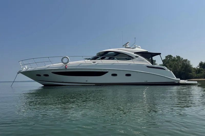 Nautalia Yacht Photos Pics 2013 Sea Ray 470 Sundancer yacht on calm water, clear sky background.