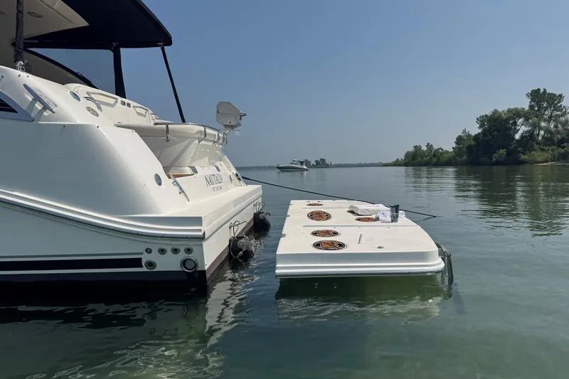 Nautalia Yacht Photos Pics 2013 Sea Ray 470 Sundancer yacht docked on calm water with scenic background.