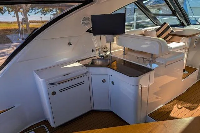 Nautalia Yacht Photos Pics 2013 Sea Ray 470 Sundancer yacht interior with kitchenette and seating area.