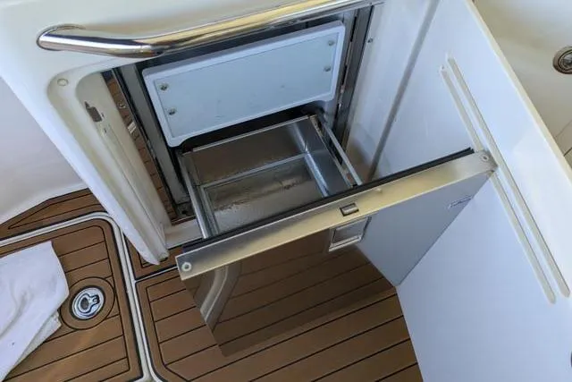 Nautalia Yacht Photos Pics Open drawer refrigerator on 2013 Sea Ray 470 Sundancer yacht with teak flooring.