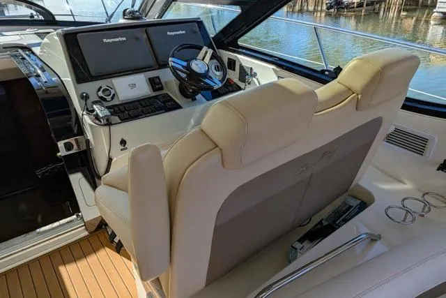 Nautalia Yacht Photos Pics Helm of 2013 Sea Ray 470 Sundancer with dual Raymarine displays and beige seating.