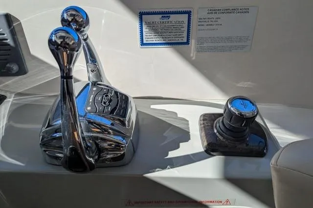 Nautalia Yacht Photos Pics Control panel of a 2013 Sea Ray 470 Sundancer yacht with throttle and joystick.