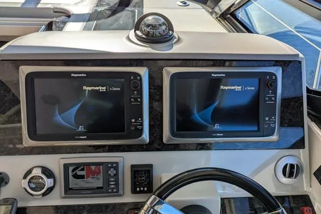 Nautalia Yacht Photos Pics 2013 Sea Ray 470 Sundancer helm with dual Raymarine displays and navigation controls.