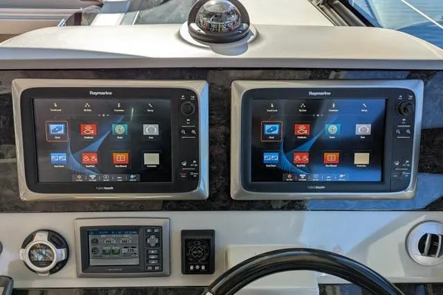 Nautalia Yacht Photos Pics Helm of 2013 Sea Ray 470 Sundancer with dual Raymarine touchscreens and navigation controls.