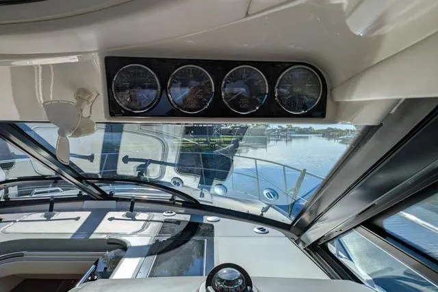 Nautalia Yacht Photos Pics Interior view of 2013 Sea Ray 470 Sundancer yacht cockpit with gauges and water view.