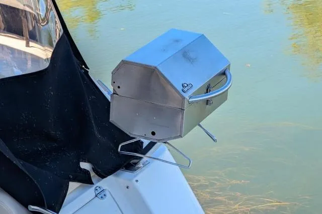 Nautalia Yacht Photos Pics Stainless steel grill mounted on 2013 Sea Ray 470 Sundancer boat by the water.