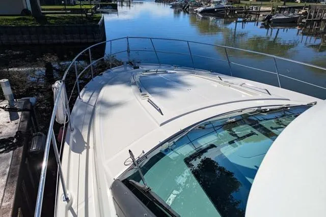 Nautalia Yacht Photos Pics 2013 Sea Ray 470 Sundancer yacht docked in a serene marina setting.