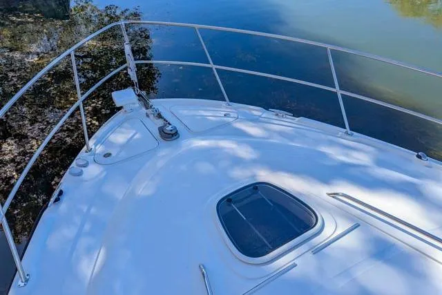 Nautalia Yacht Photos Pics Bow of 2013 Sea Ray 470 Sundancer yacht on calm water.