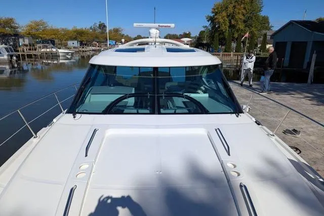 Nautalia Yacht Photos Pics 2013 Sea Ray 470 Sundancer yacht docked, showcasing sleek design and spacious deck.