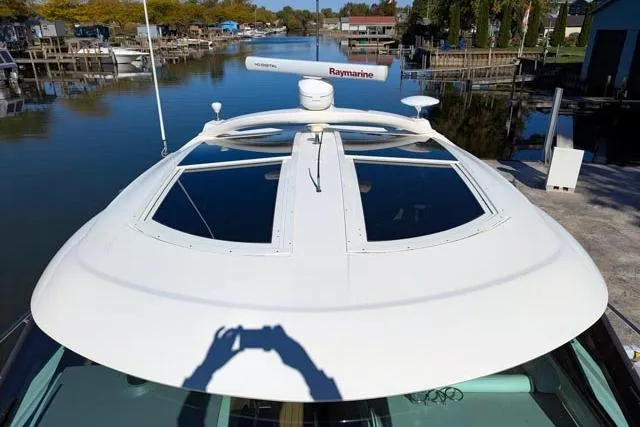 Nautalia Yacht Photos Pics 2013 Sea Ray 470 Sundancer yacht with Raymarine radar on a calm waterway.