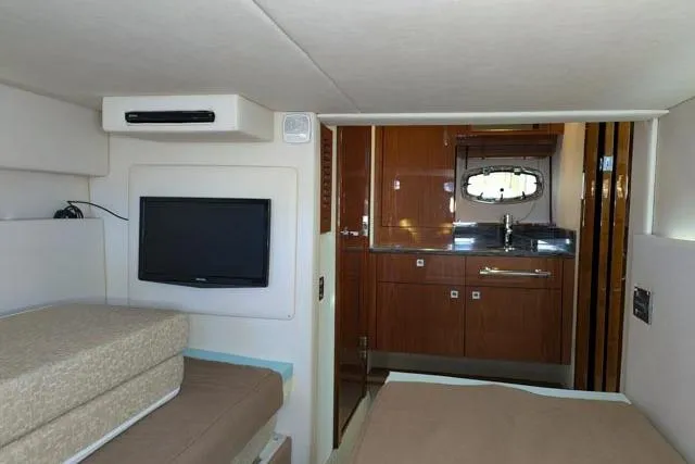 Nautalia Yacht Photos Pics Interior of 2013 Sea Ray 470 Sundancer yacht with TV, bed, and kitchenette.