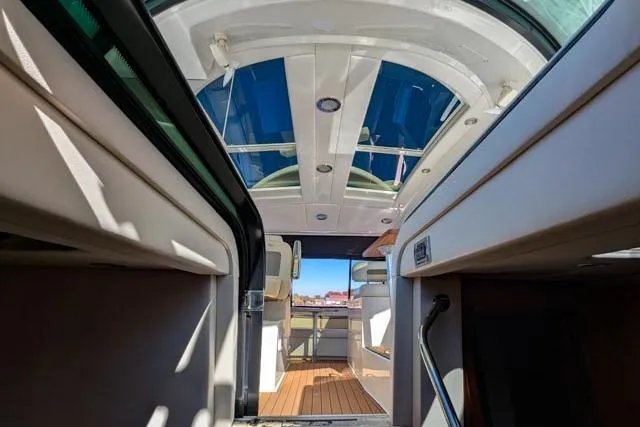 Nautalia Yacht Photos Pics Interior view of 2013 Sea Ray 470 Sundancer yacht with sunroof and seating area.