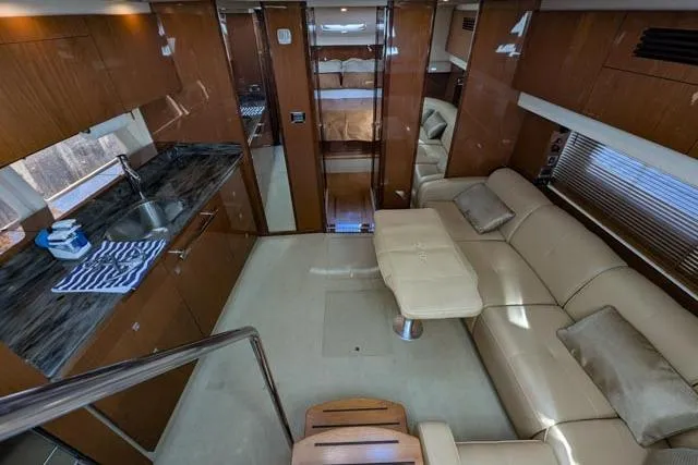 Nautalia Yacht Photos Pics Luxurious interior of 2013 Sea Ray 470 Sundancer yacht with modern kitchen and comfortable seating.
