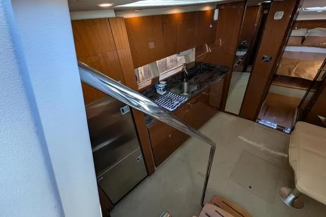 Nautalia Yacht Photos Pics Interior of 2013 Sea Ray 470 Sundancer yacht with modern kitchen and cozy cabin.