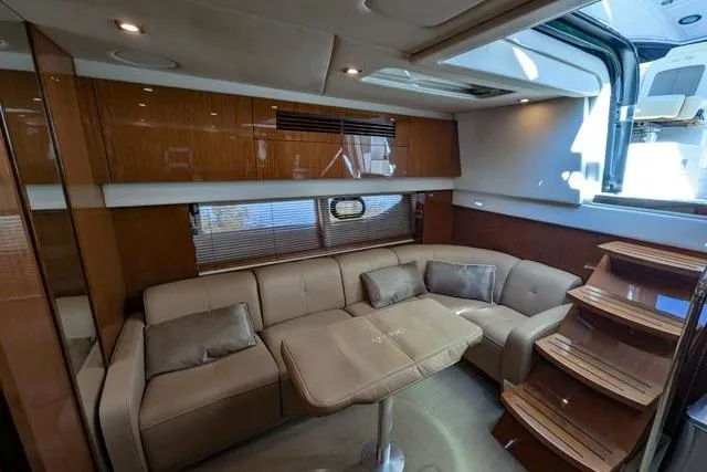 Nautalia Yacht Photos Pics Luxurious interior of 2013 Sea Ray 470 Sundancer yacht with plush seating and wooden accents.