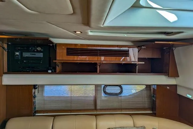 Nautalia Yacht Photos Pics Interior of 2013 Sea Ray 470 Sundancer yacht with wood paneling and seating.