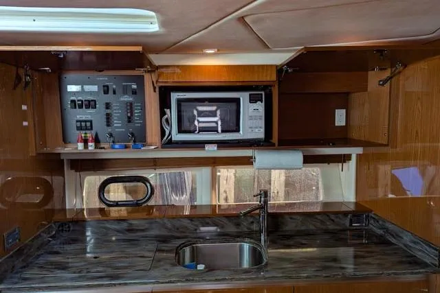Nautalia Yacht Photos Pics 2013 Sea Ray 470 Sundancer kitchen with microwave, sink, and control panel.