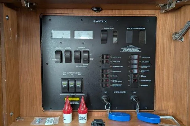 Nautalia Yacht Photos Pics 2013 Sea Ray 470 Sundancer control panel with switches and gauges in wooden cabinet.