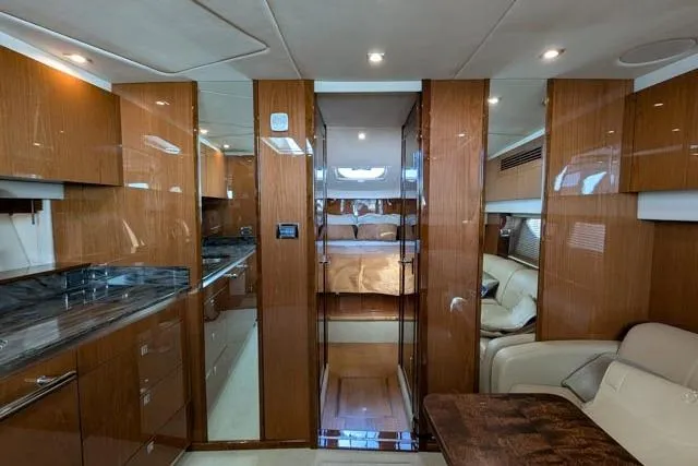 Nautalia Yacht Photos Pics Luxurious interior of 2013 Sea Ray 470 Sundancer yacht with wood finishes and modern amenities.