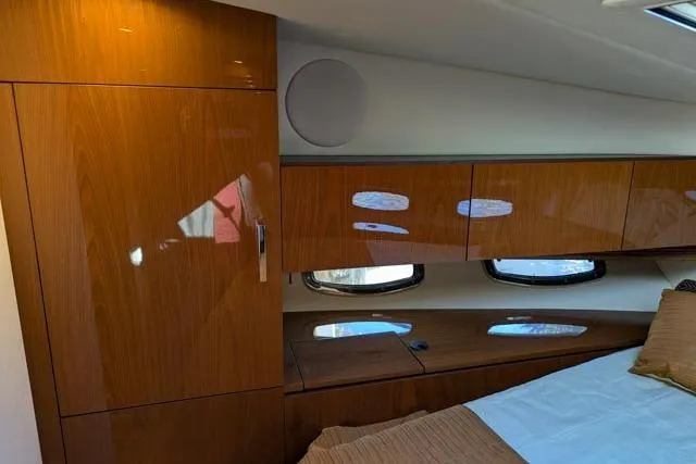 Nautalia Yacht Photos Pics Luxurious cabin interior of 2013 Sea Ray 470 Sundancer yacht with wood finish.