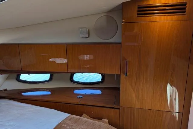 Nautalia Yacht Photos Pics Interior cabin of 2013 Sea Ray 470 Sundancer with wooden cabinets and windows.