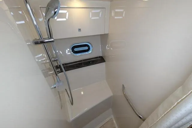 Nautalia Yacht Photos Pics 2013 Sea Ray 470 Sundancer yacht bathroom with shower, porthole, and sleek design.