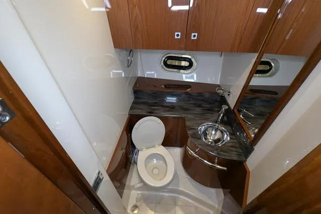 Nautalia Yacht Photos Pics Luxurious bathroom in 2013 Sea Ray 470 Sundancer yacht with modern fixtures and wood cabinetry.