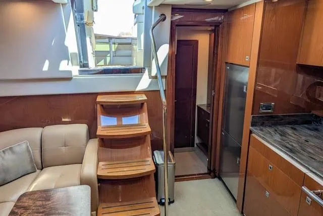 Nautalia Yacht Photos Pics Interior of 2013 Sea Ray 470 Sundancer yacht with wooden stairs and modern kitchen.
