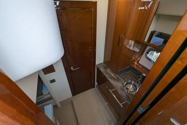 Nautalia Yacht Photos Pics Interior of 2013 Sea Ray 470 Sundancer yacht, featuring sleek wood cabinetry and compact sink.