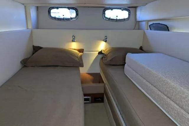 Nautalia Yacht Photos Pics Interior cabin of 2013 Sea Ray 470 Sundancer with twin beds and ambient lighting.