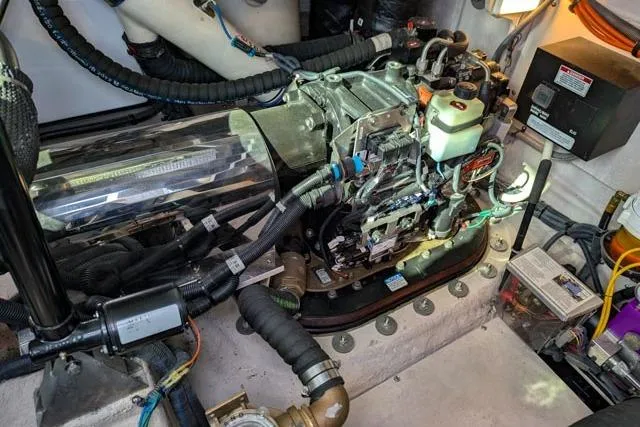 Nautalia Yacht Photos Pics Engine room of 2013 Sea Ray 470 Sundancer, showcasing mechanical components and wiring.