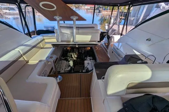 Nautalia Yacht Photos Pics 2013 Sea Ray 470 Sundancer yacht interior with engine compartment open, docked by the water.