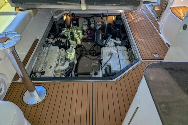 Nautalia Yacht Photos Pics Engine compartment of 2013 Sea Ray 470 Sundancer yacht with twin engines and teak flooring.