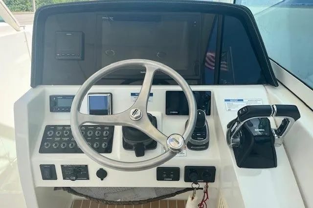  Yacht Photos Pics 2018 World Cat 320 DC helm with steering wheel, controls, and navigation instruments.
