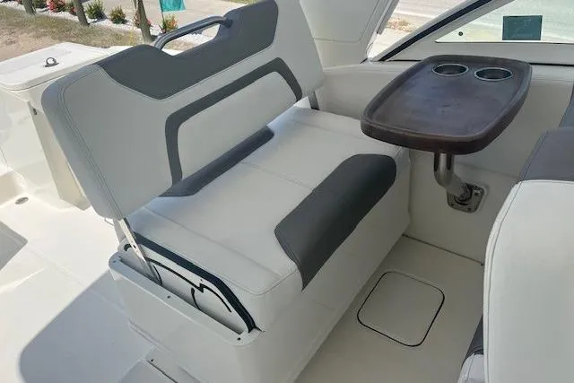  Yacht Photos Pics 2018 World Cat 320 DC boat interior with cushioned seating and a small table.