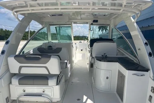  Yacht Photos Pics 2018 World Cat 320 DC boat interior with seating and helm, featuring modern design and amenities.