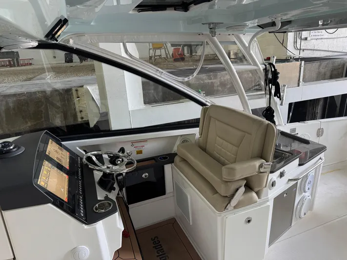  Yacht Photos Pics 2019 Everglades 340 Dual Console boat interior with steering wheel and navigation display.