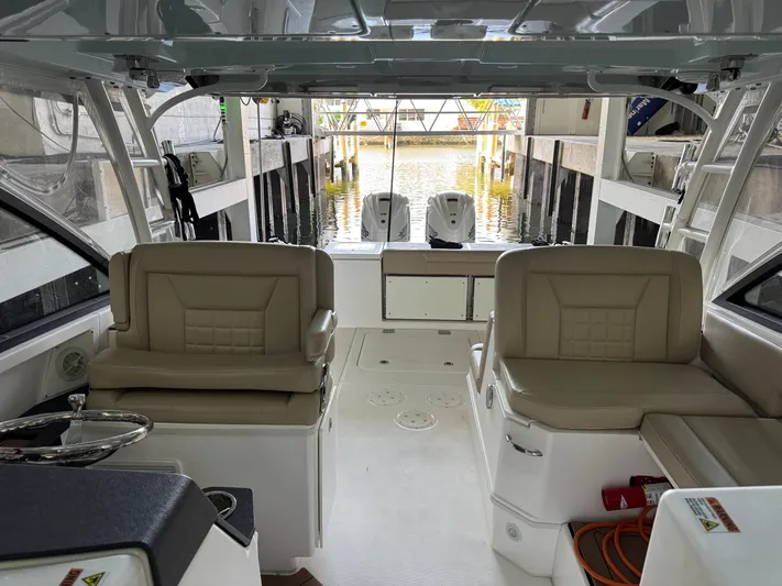  Yacht Photos Pics Interior view of a 2019 Everglades 340 Dual Console boat with beige seating.