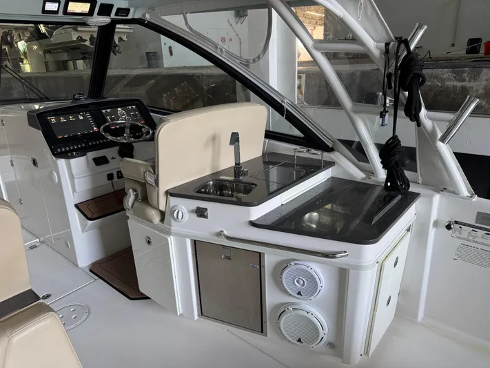  Yacht Photos Pics 2019 Everglades 340 Dual Console boat interior with helm, sink, and seating area.
