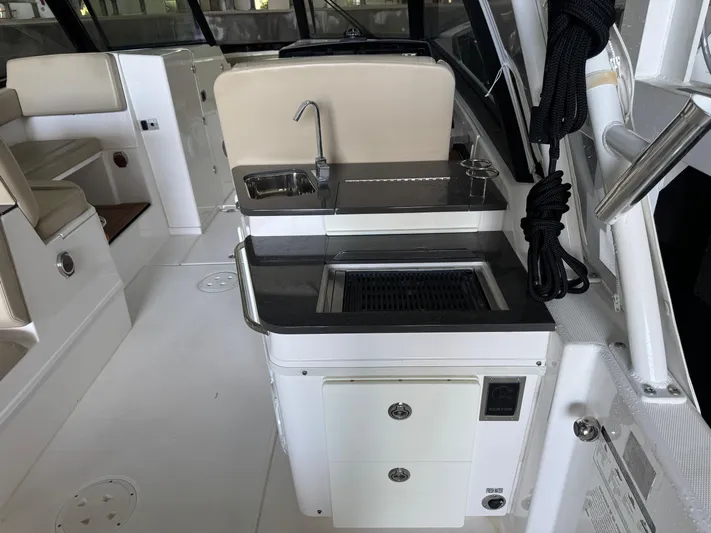  Yacht Photos Pics 2019 Everglades 340 Dual Console boat interior with sink and seating area.