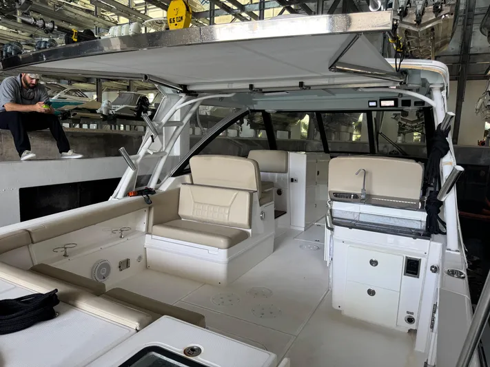  Yacht Photos Pics 2019 Everglades 340 Dual Console boat interior with seating and kitchenette in a marina.