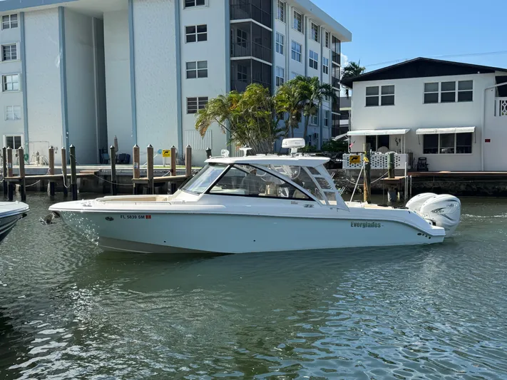  Yacht Photos Pics 2019 Everglades 340 Dual Console boat docked near waterfront buildings.