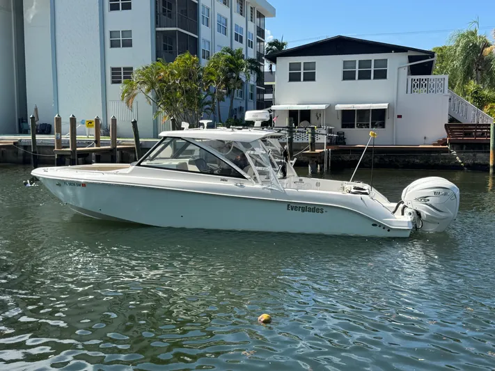 Yacht Photos Pics 2019 Everglades 340 Dual Console boat docked near waterfront homes.