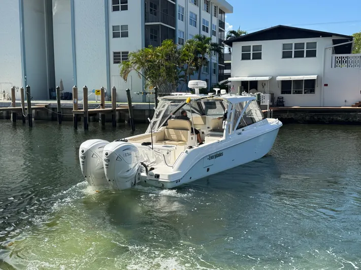  Yacht Photos Pics 2019 Everglades 340 Dual Console boat docked near waterfront buildings.
